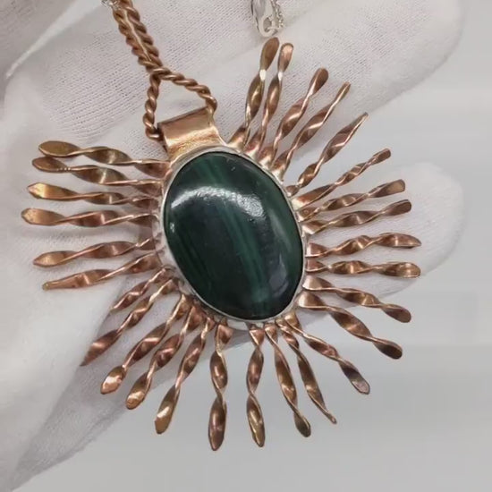 Video demo of the starburst malachite pendant in a human hand.