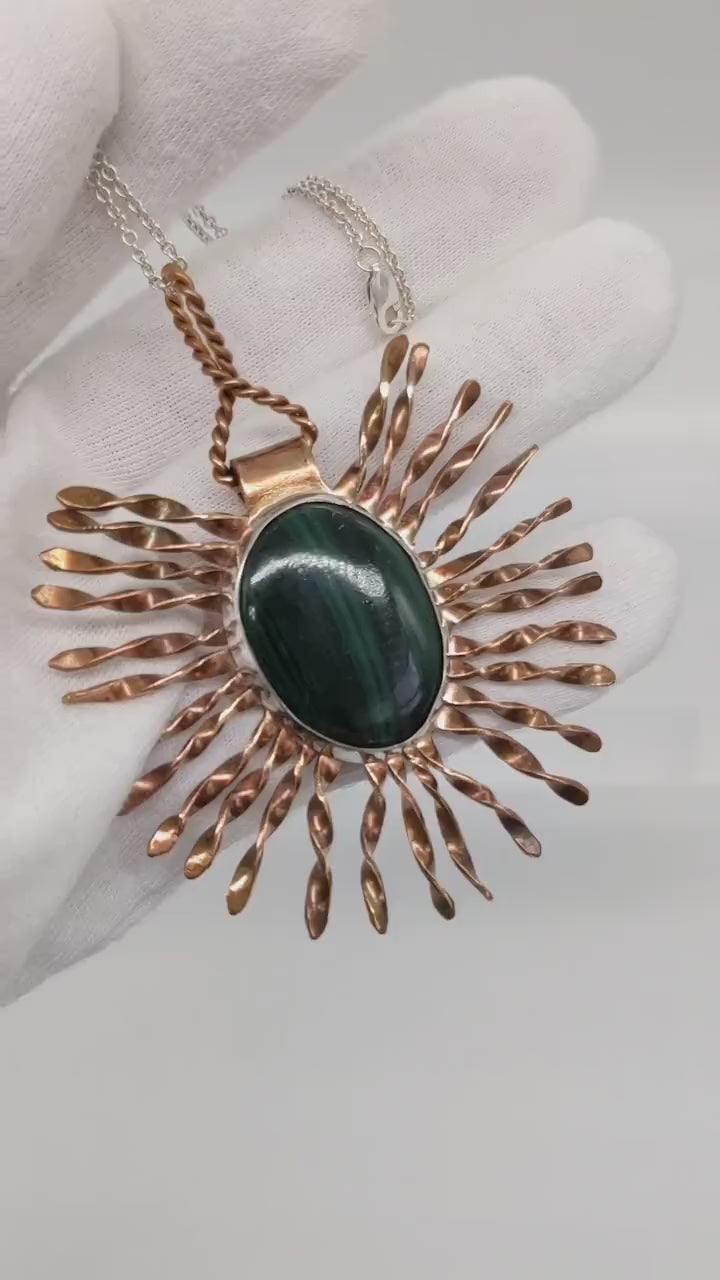 Video demo of the starburst malachite pendant in a human hand.