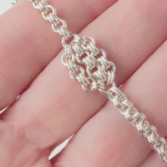 Video Demo closeup of floret and double cable design of Argentium silver necklace.