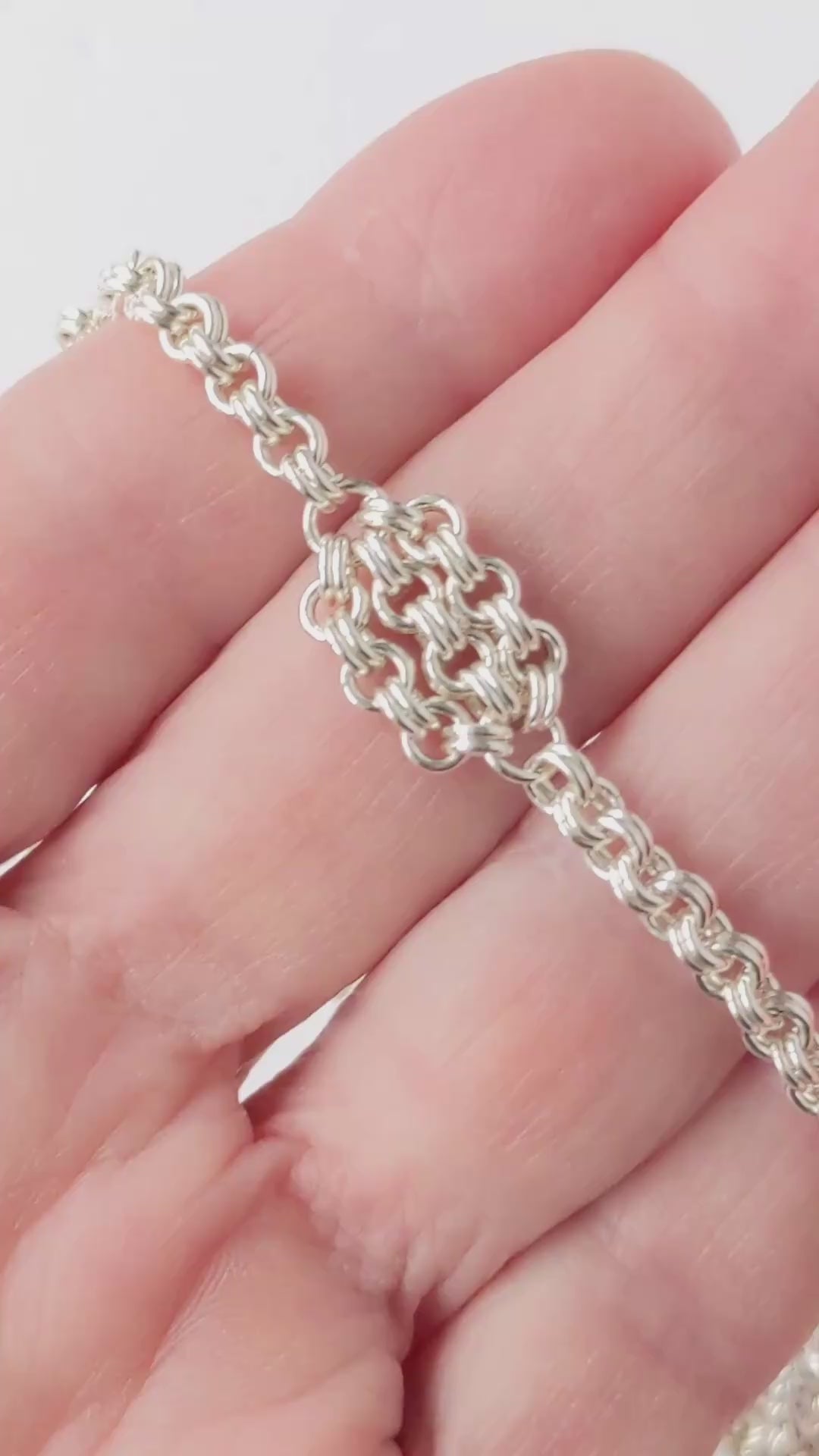 Video Demo closeup of floret and double cable design of Argentium silver necklace.
