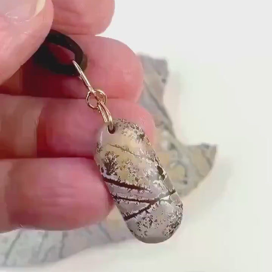 Demo Clip of Sonoran Dendtritic Pendant in palm of hand showing both sides of pendant against white background.