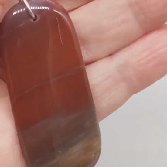 See the Glow: This short video shows the pendant illuminated from behind with a flashlight, revealing the natural translucence and warm internal glow of Petrified Rainbow Wood. Demo of Tag-Shaped Petrified Rainbow Wood Pendant – Handcrafted Focal Piece for Jewelry Making, Fossilized woodHandcrafted in USA, 2.67"