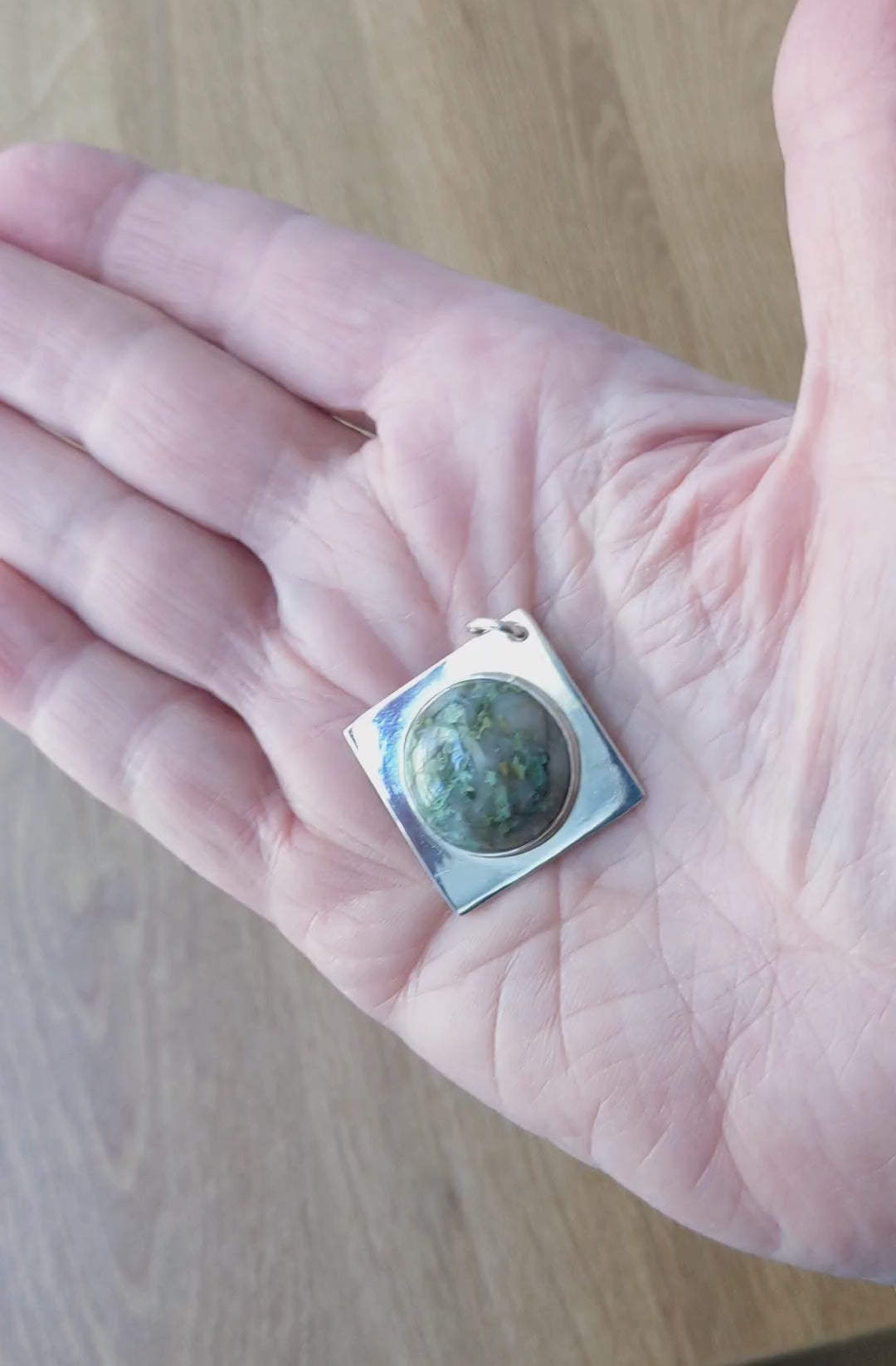 Demo clip in hand of this Natural green Variscite pendant in Argentium 935 silver with Argentium silver chain