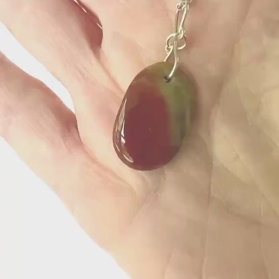 Demo clip of sonoran sunrise pendant in hand showing the color and texture of both sides of pendant.