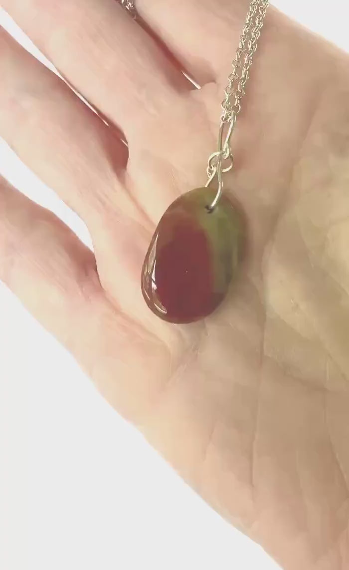 Demo clip of sonoran sunrise pendant in hand showing the color and texture of both sides of pendant.