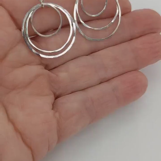 Silver Hammered Earrings demo in palm of hand.
