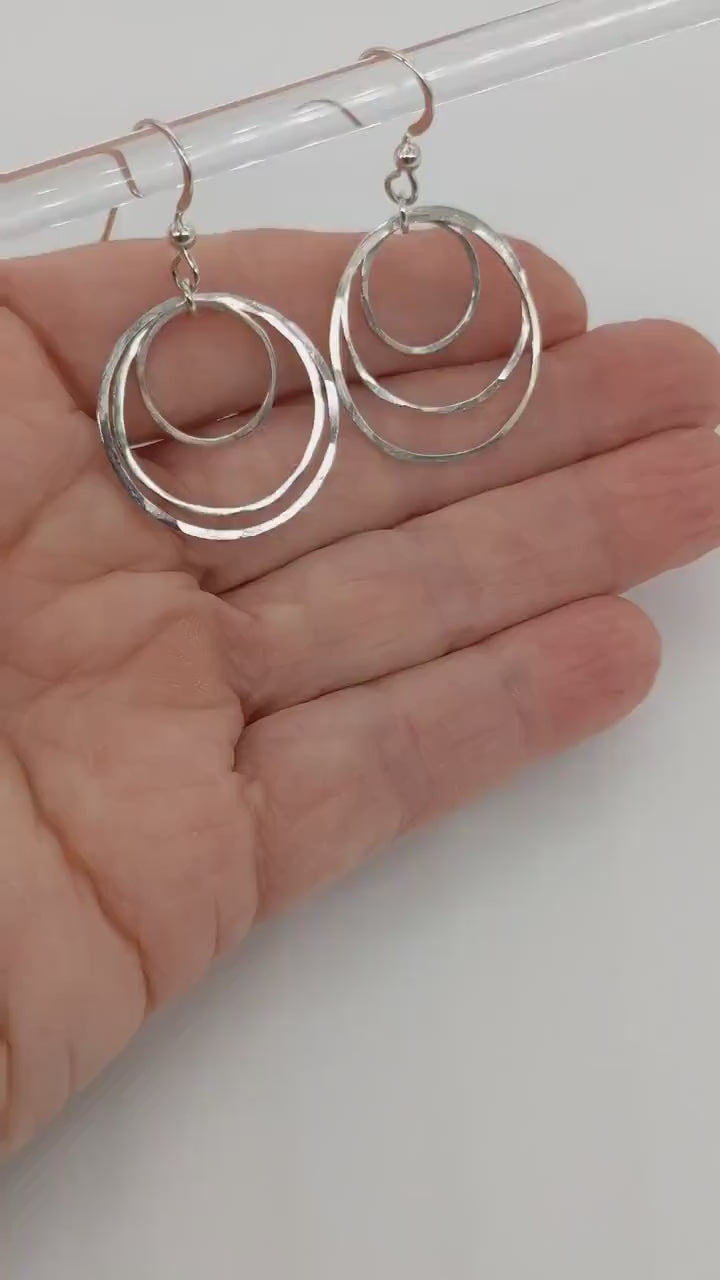 Silver Hammered Earrings demo in palm of hand.