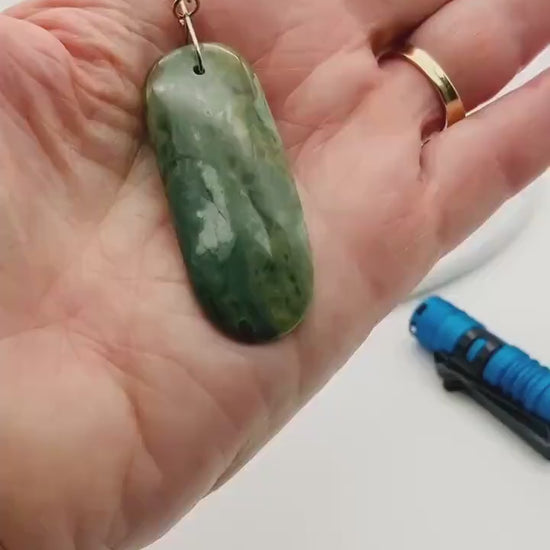 Demo clip of California Nephrite Jade pendant showing the translucent nature of the pendant with a back light.