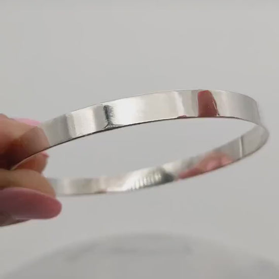 Flat Bangle Bracelet in tarnish resistant and hypoallergenic Argentium® 935 silver.  Shown on white background.