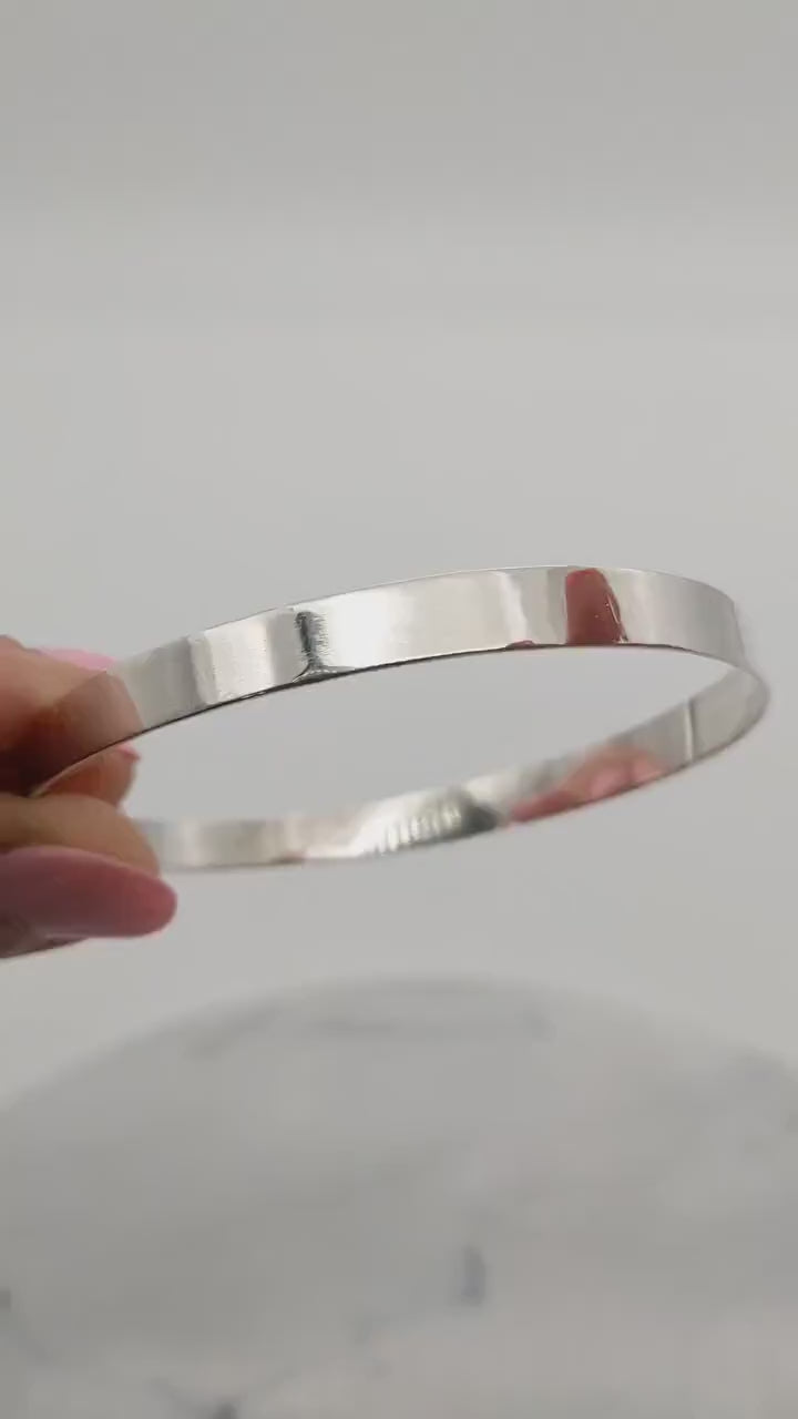 Flat Bangle Bracelet in tarnish resistant and hypoallergenic Argentium® 935 silver.  Shown on white background.