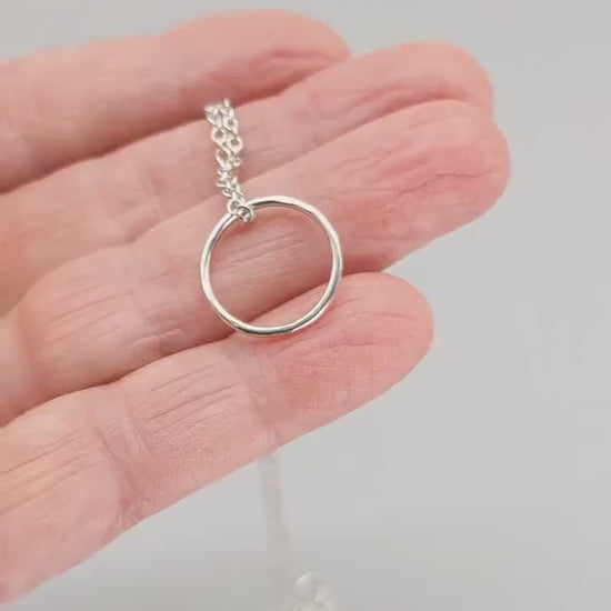 Demo clip showing a handcrafted circle pendant necklace in 935 Argentium silver