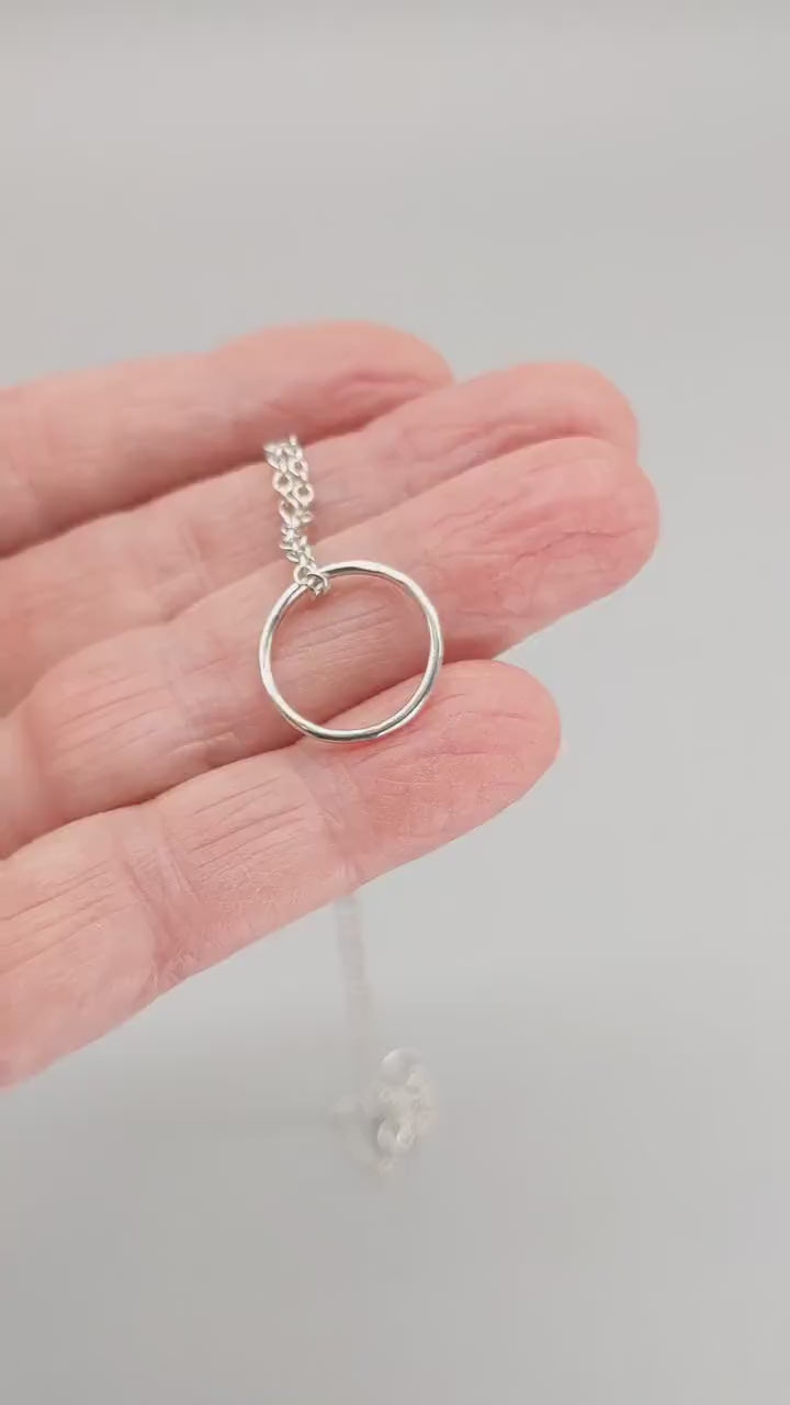 Demo clip showing a handcrafted circle pendant necklace in 935 Argentium silver