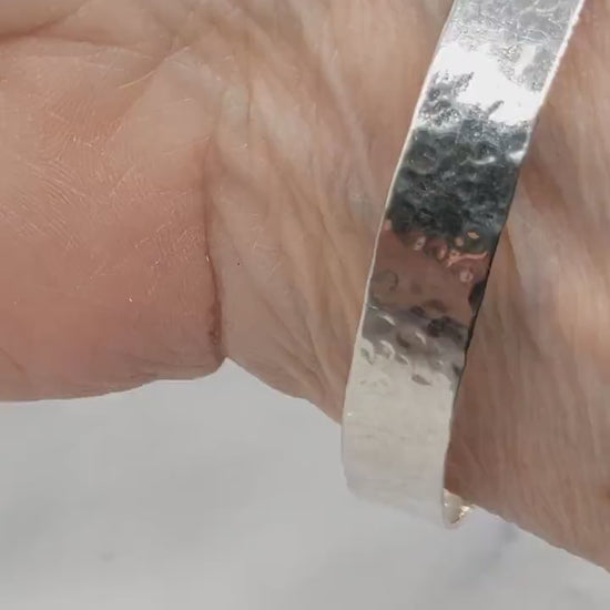 Demo clip of Argentium Silver Bangle on human wrist against marble and white background.