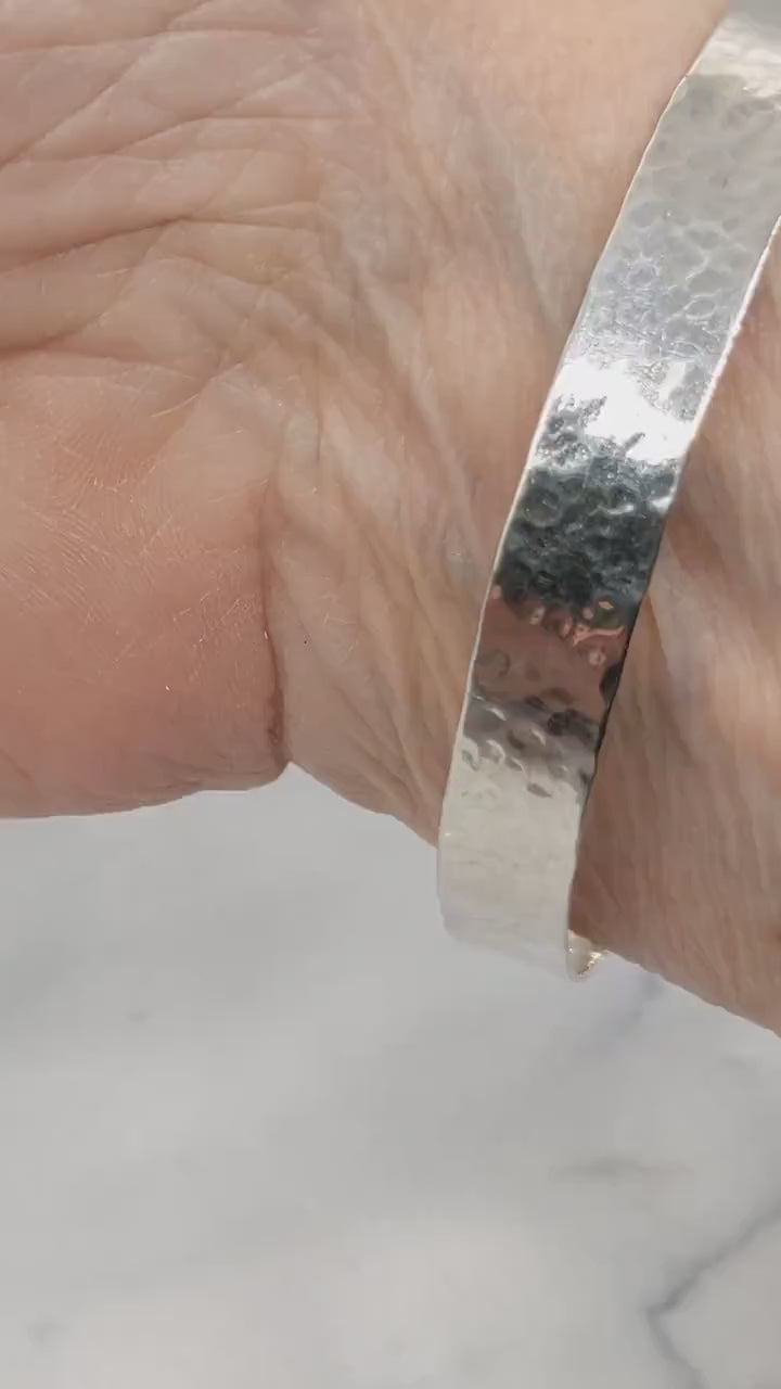 Demo clip of Argentium Silver Bangle on human wrist against marble and white background.