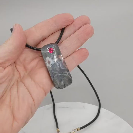 Video demo of this one-of-a-kind Red Mexican agate pendant shown in a human palm both sides of pendant are demonstrated.