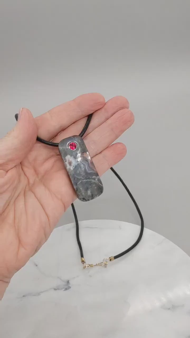 Video demo of this one-of-a-kind Red Mexican agate pendant shown in a human palm both sides of pendant are demonstrated.