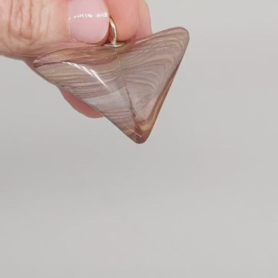  This short video shows the pendant revealing the natural colors and patterns of Petrified Rainbow Wood. 