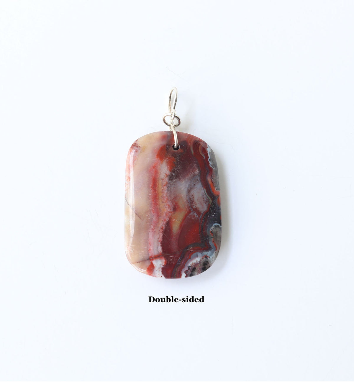 A polished rectangular pendant with rounded corners, featuring a marbled pattern of red, brown, cream, and black, with silver bail. The pendant is displayed against a solid white background with the text 'Double-sided' printed below it.  