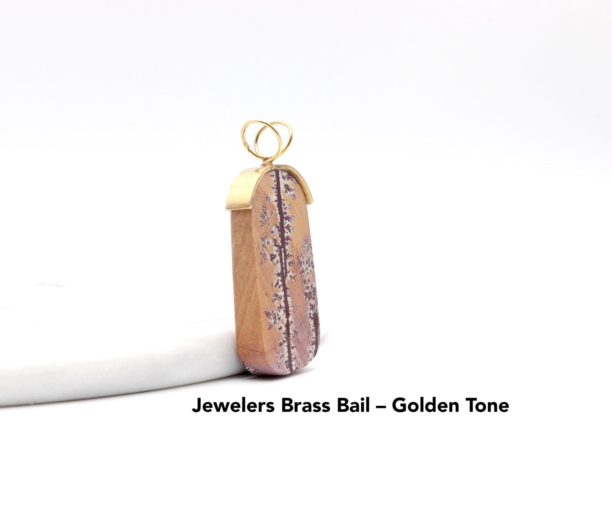 Shown a side view of this one-of-a-kind tag-shaped Sonoran Dendritic Rhyolite pendant featuring a jeweler’s brass cap and split wire bail.
