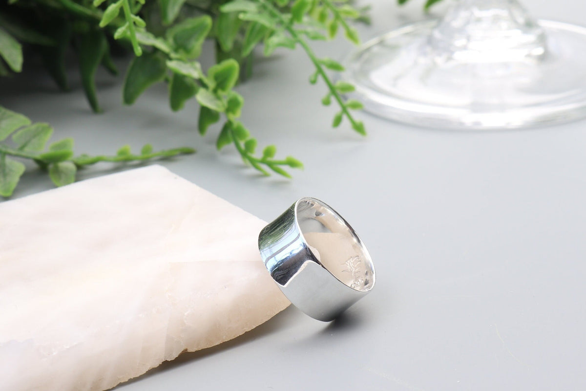 Solid Argentium 935 silver wide band ring with polished anticlastic contour and Elkhorn Silver maker's mark