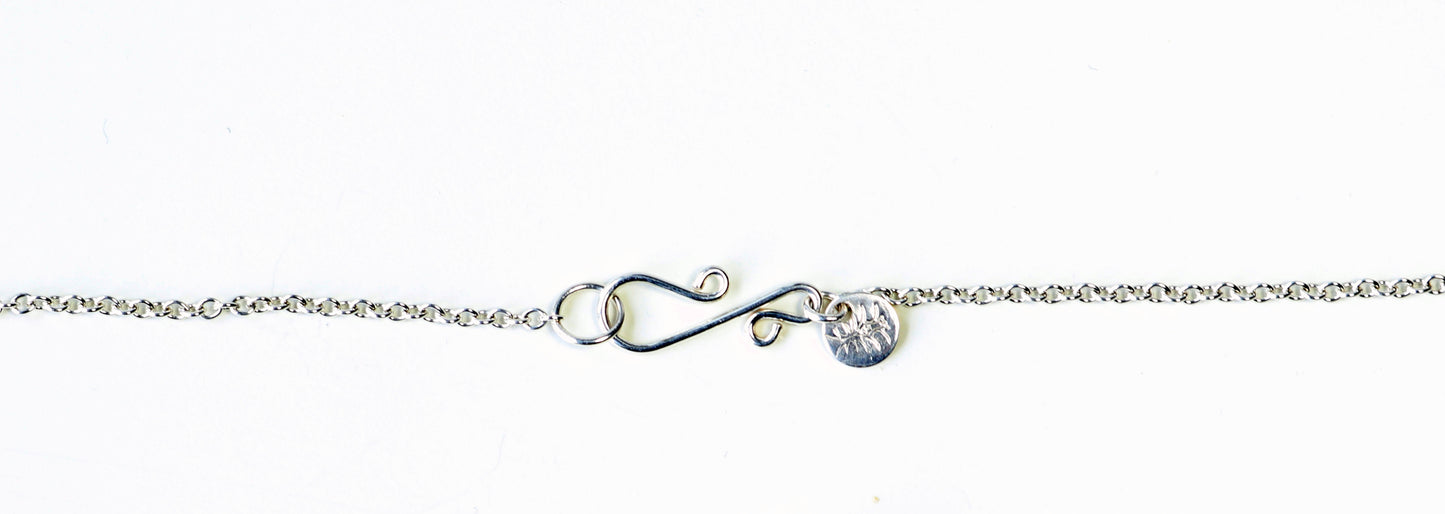 Custom S-hook clasp in Argentium Silver shown on white background