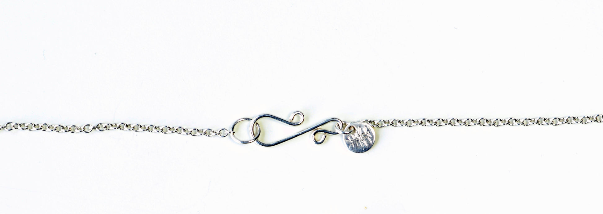 Custom S-hook clasp in Argentium Silver shown on white background