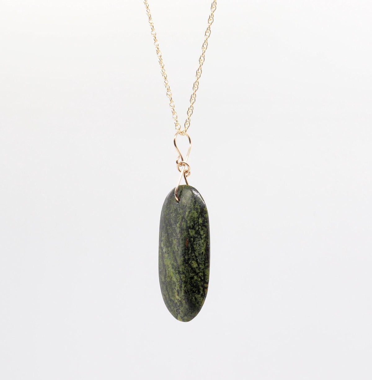 side view of Forest Green Jasper Pendant – suspended from gold-filled rope chain necklace against light gray background.