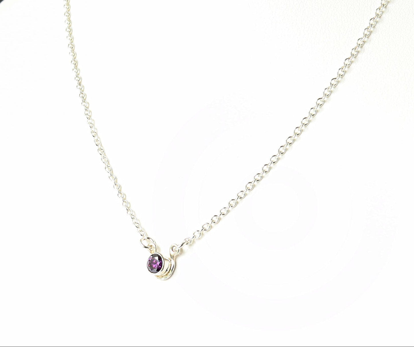 Necklace with a purple gemstone on a mannequin