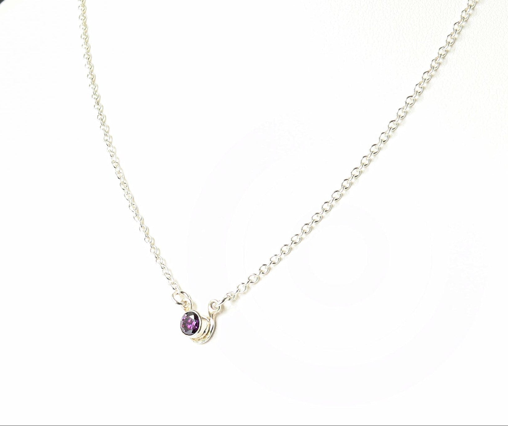 Necklace with a purple gemstone on a mannequin