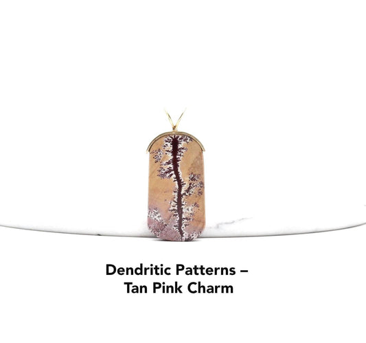 Sonoran Dendritic Rhyolite Pendant – Brass Bail shown against white marble with text overlay Dendritic Patterns - Tan Pink Charm