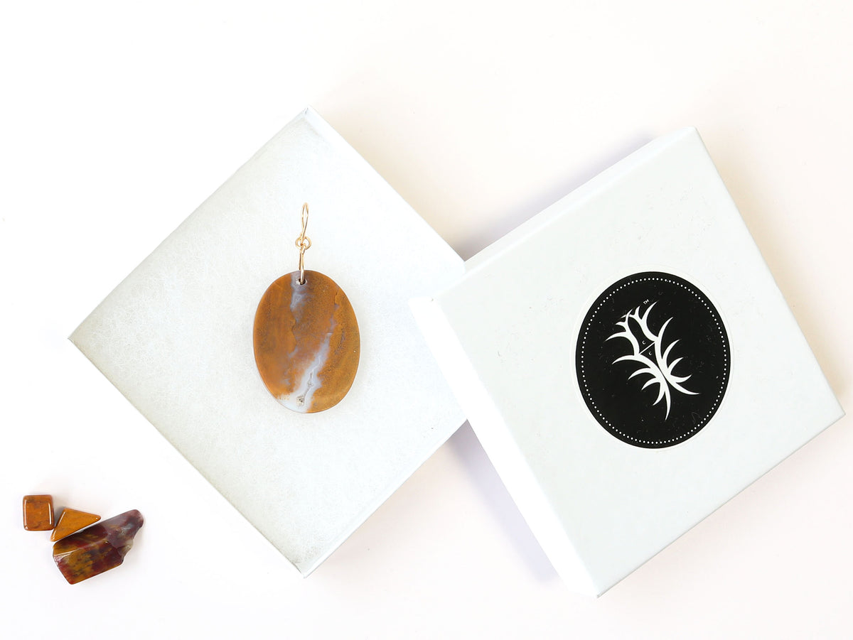 One-of-a-Kind Sonoran Sunrise Pendant – Hand-Cut in Missouri with warm golden ochre tones with soft white veining and natural crystal inclusions.  Shown in white gift box with chips of sonoran sunrise against white background.