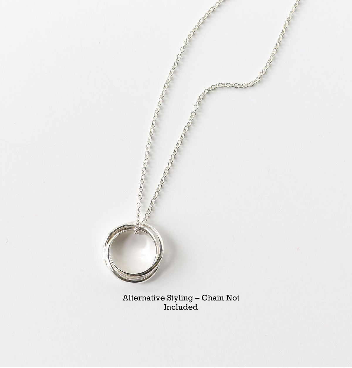 Handcrafted solid sterling silver rolling ring with three interlocking polished bands shown on Argentium chain for styling inspiration. Text reads 'Alternative Styling-Chain Not Included'