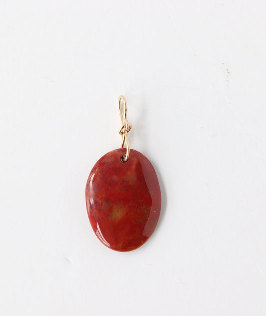 One-of-a-kind Sonoran Sunrise pendant, polished on both sides and finished with a handcrafted 14/20 gold-filled infinity bow-style bail.The jewelry is set against a white background.