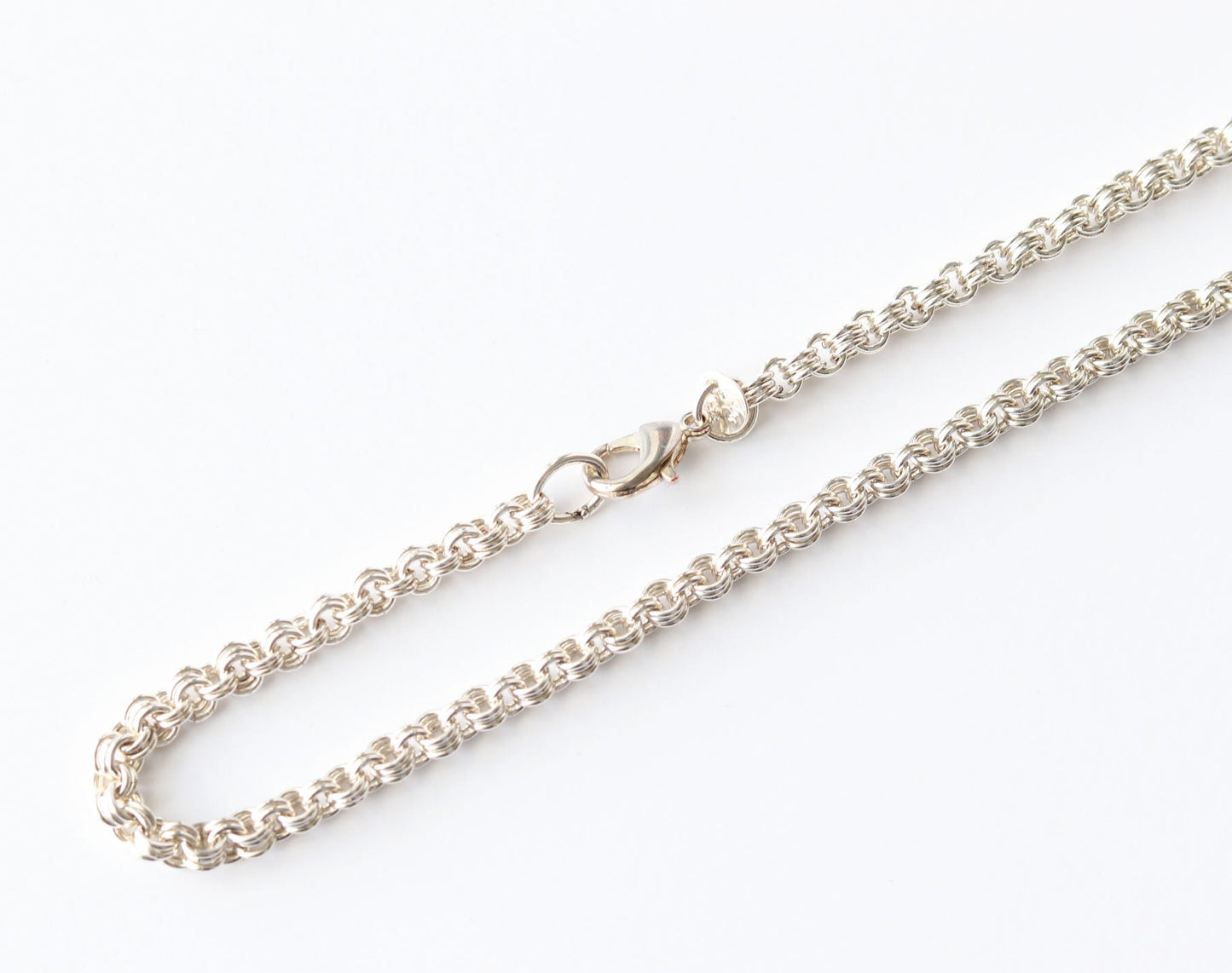 Argentium Silver chain closeup necklace on a white background featuring teardrop lobster clasp.