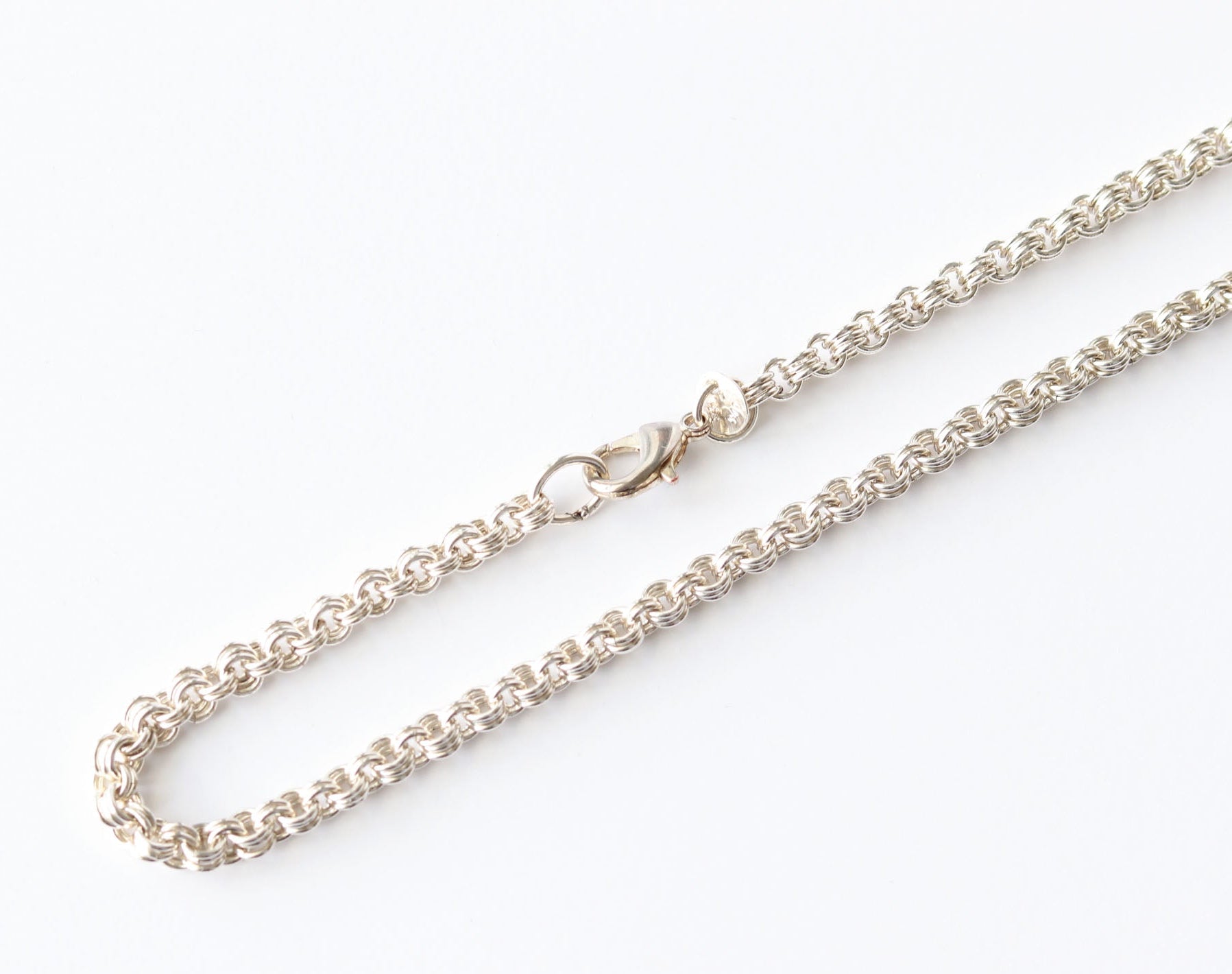Argentium Silver chain closeup necklace on a white background featuring teardrop lobster clasp.