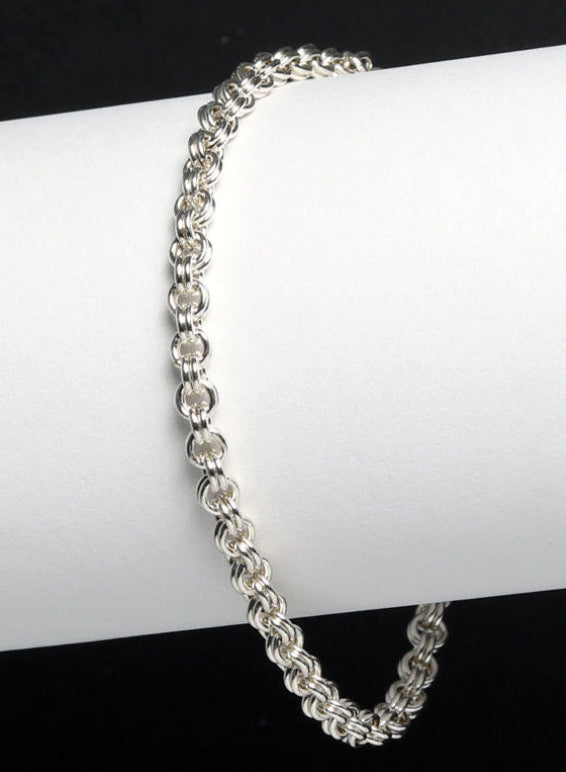Argentium Silver double cable chain bracelet on a white surface with a black background